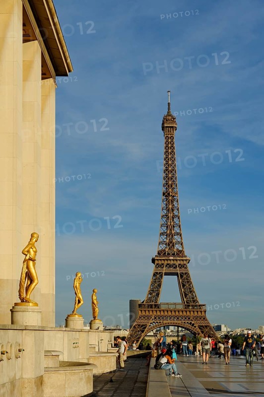 Golden statues at the Palais de Chaillot with the Eiffel Tower