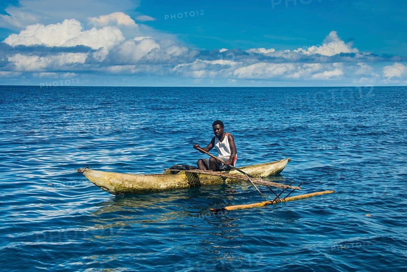 Man in an outrigger boat