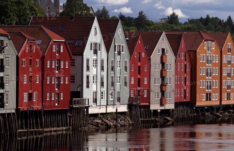 Colourful wooden houses on stilts on the Nidelv River