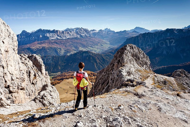 Mountain climber descending from Peitlerkofel Mountain in Puez-Geisler Nature Park