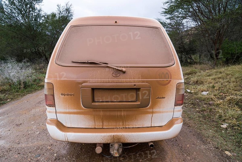 Dusty car on on a gravel road