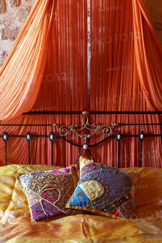 Romantic metal bed with canopy and two oriental silk cushions