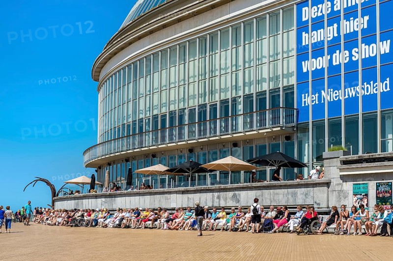 People sunbathing in front of the Oostende Casino