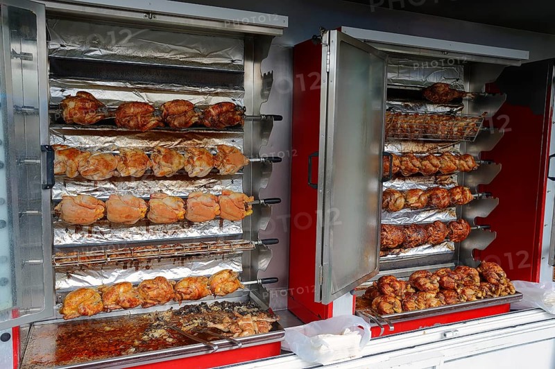 Market stall with a chicken grill and fried chicken