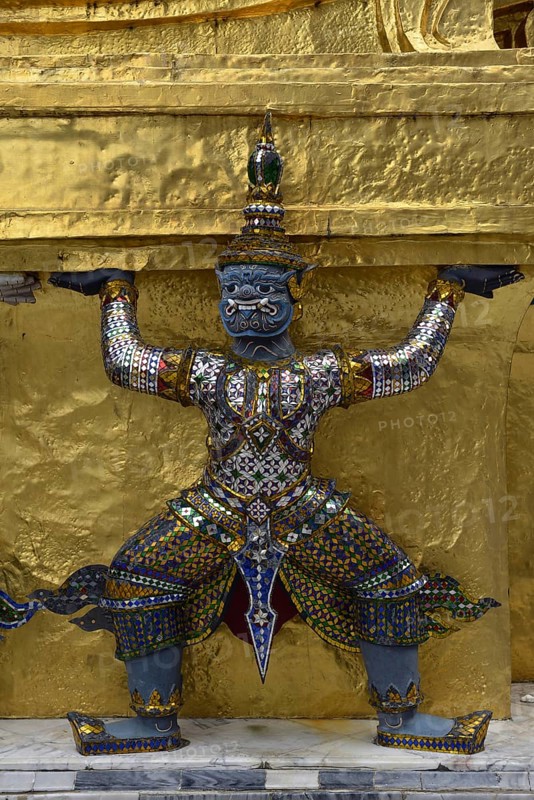Guardian figure on a golden chedi