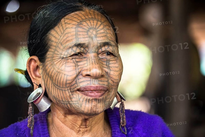 Woman with a traditional facial tattoo and ear jewelry