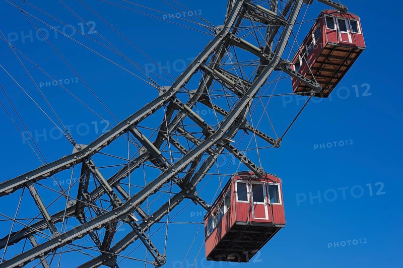 Two cabins of the Wiener Riesenrad ferris wheel against a blue sky at the Prater