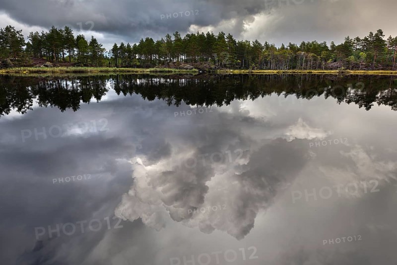 Naveretjarn Lake with dramatic clouds and mirroring