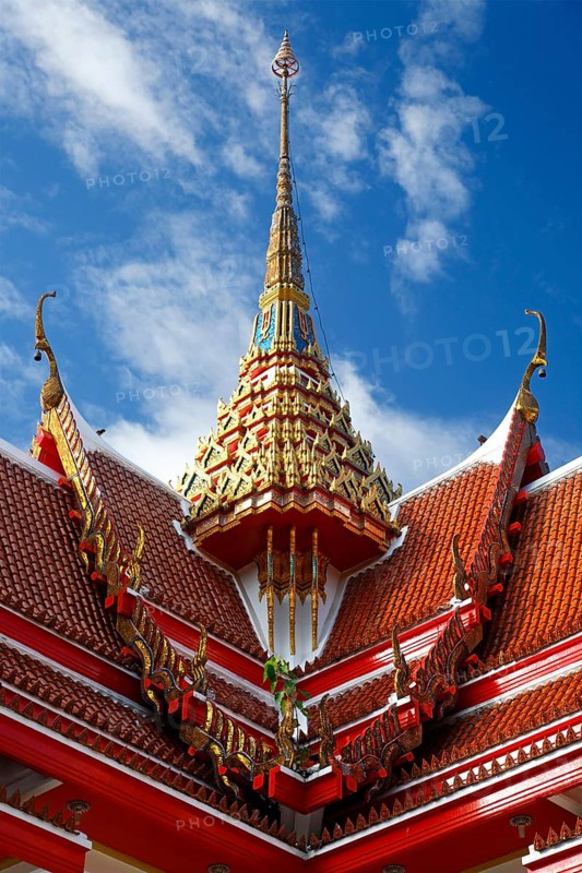 Red roof of a pagoda with an ornate spire