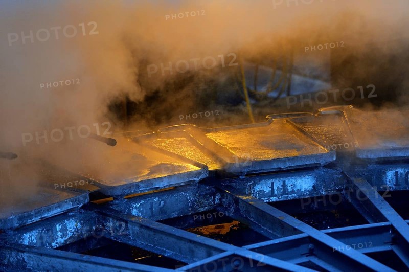 Liquid silver is being poured into molds