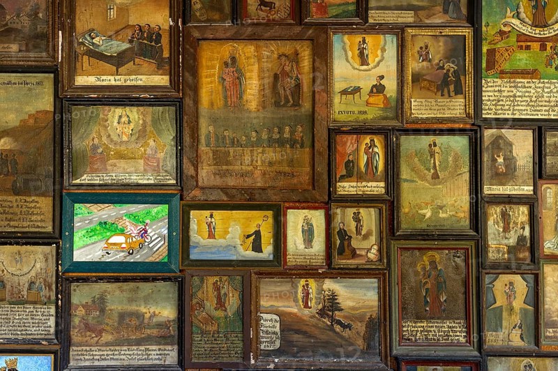 Old and newer votive offerings in the cloister around the Shrine of Our Lady of Altotting