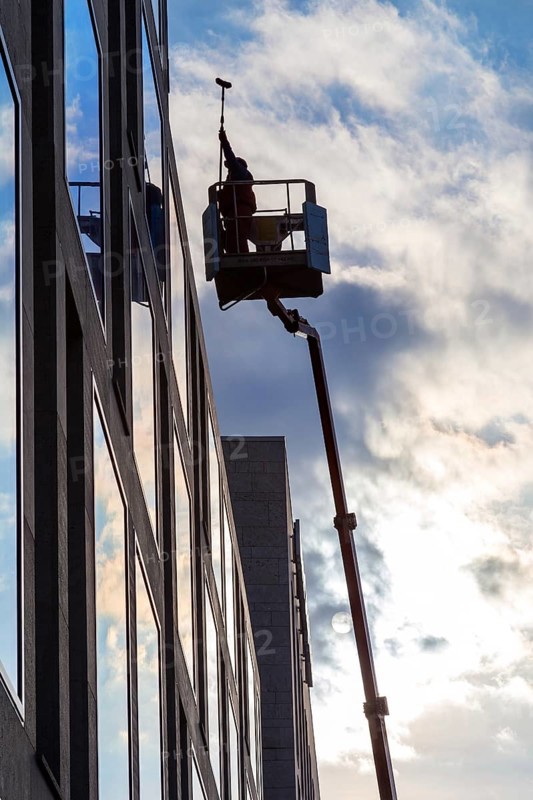 Window cleaner cleaning the windows of a hotel