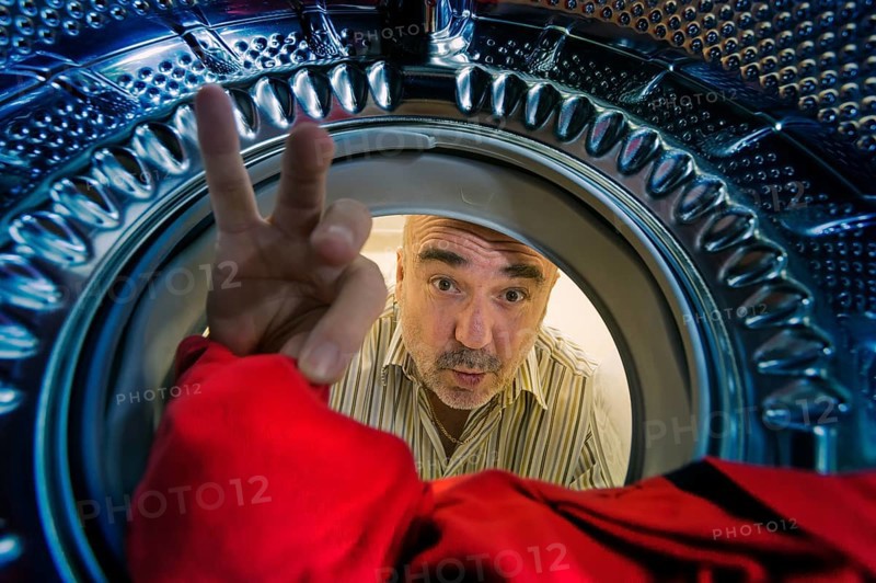 Man looking into a washing machine