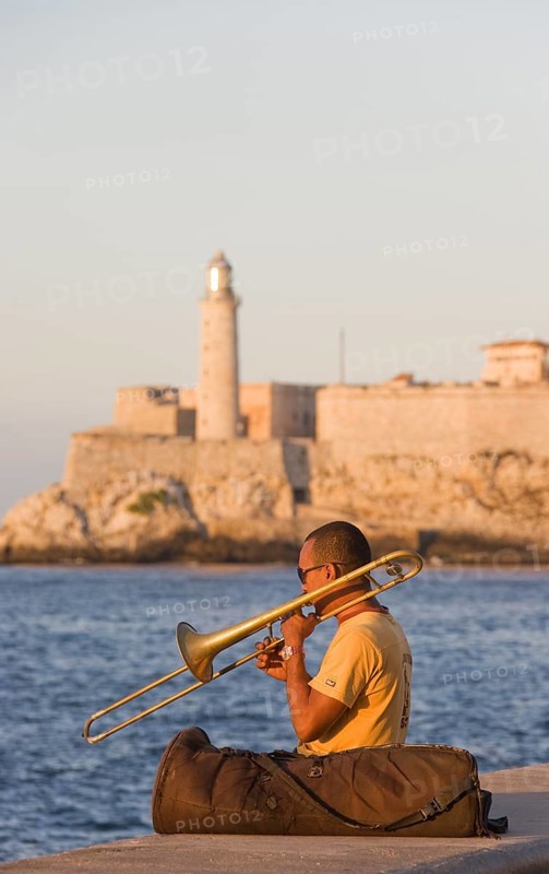 Musician playing the trombone at the Malecon esplanade