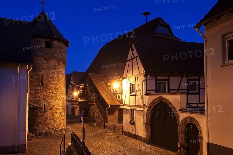 Historical Town Hall with a fortified wall and the tower of a fortified church