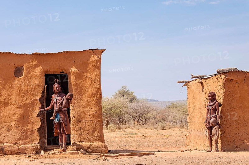 Himba women with children in front of their mud huts