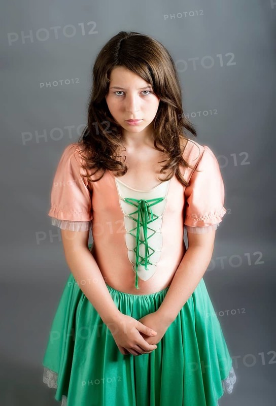 Girl wearing an old-fashioned dress looking sad