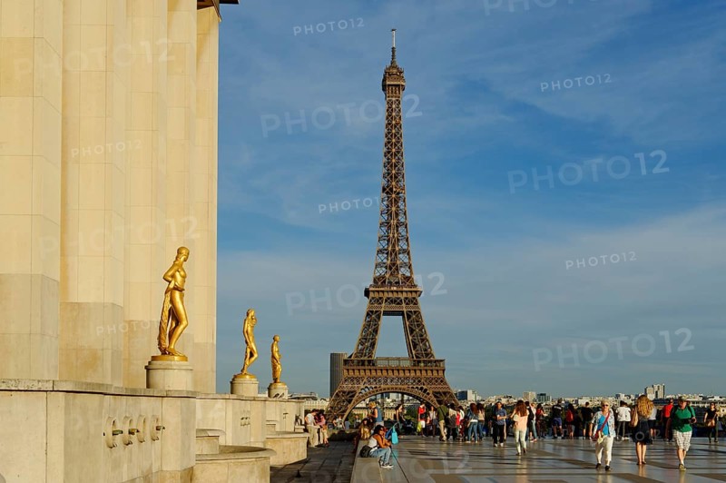 Golden statues at the Palais de Chaillot with the Eiffel Tower