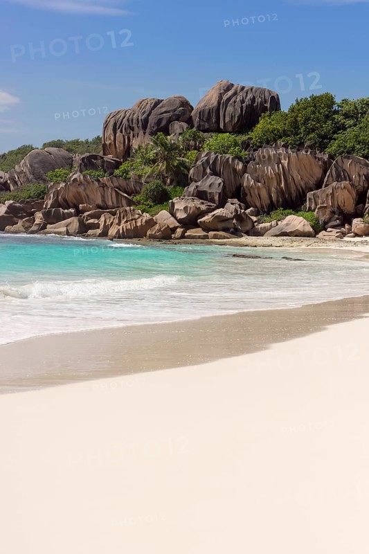 Sandy beach with the rock formations typical for the Seychelles