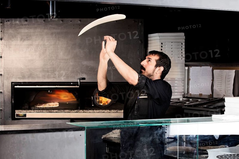 Pizza baker preparing the pizza dough