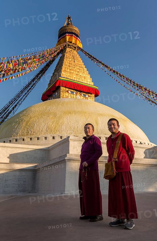Two monks walking around Boudhanath stupa