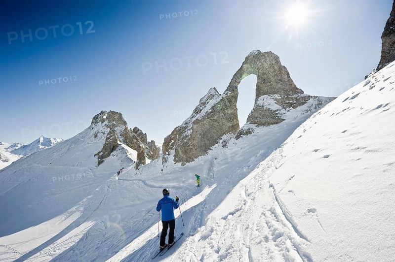 Skiers and snow-covered mountains