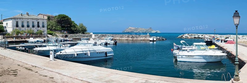 The marina of Macinaggio with the barrier island La Giraglia