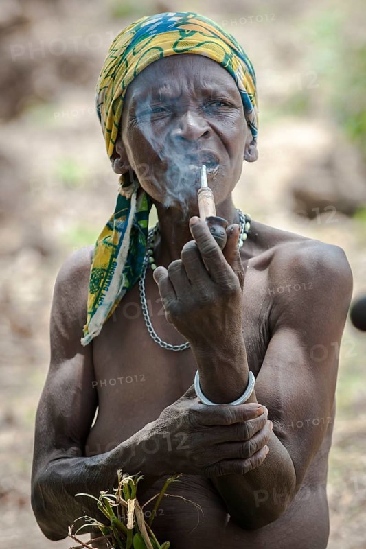 A woman from the Koma people smoking a pipe