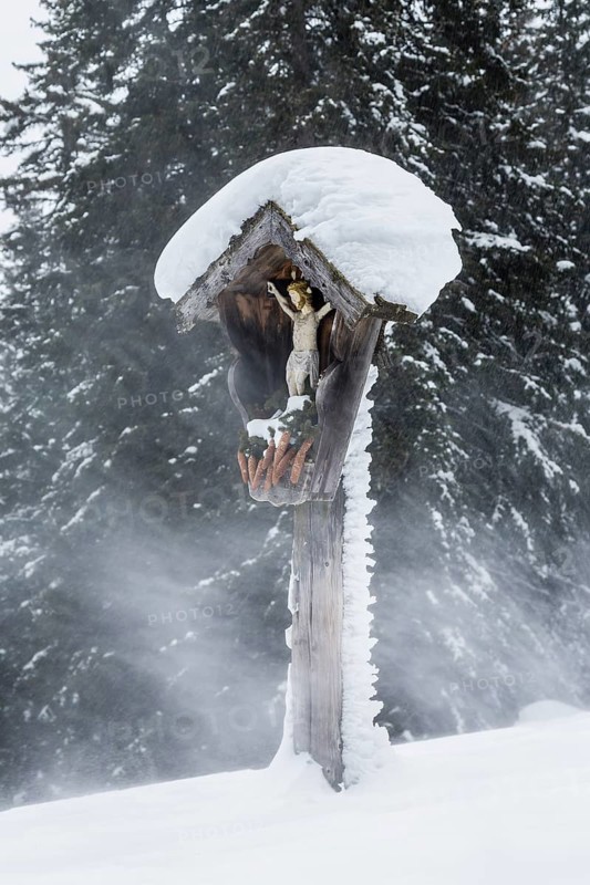 Wayside shrine during a snowstorm
