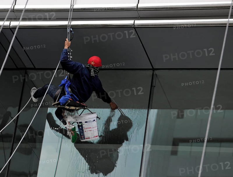 Window cleaner cleaning a window pane