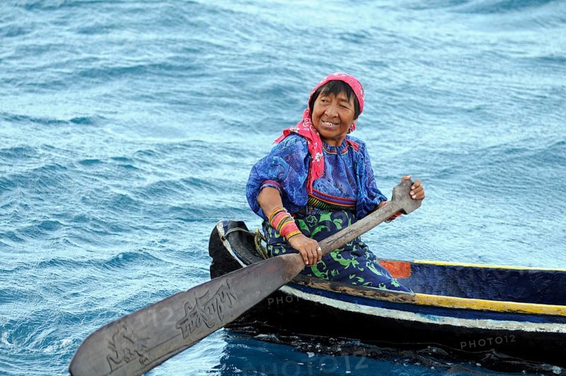 Kuna Indian woman in a dugout canoe