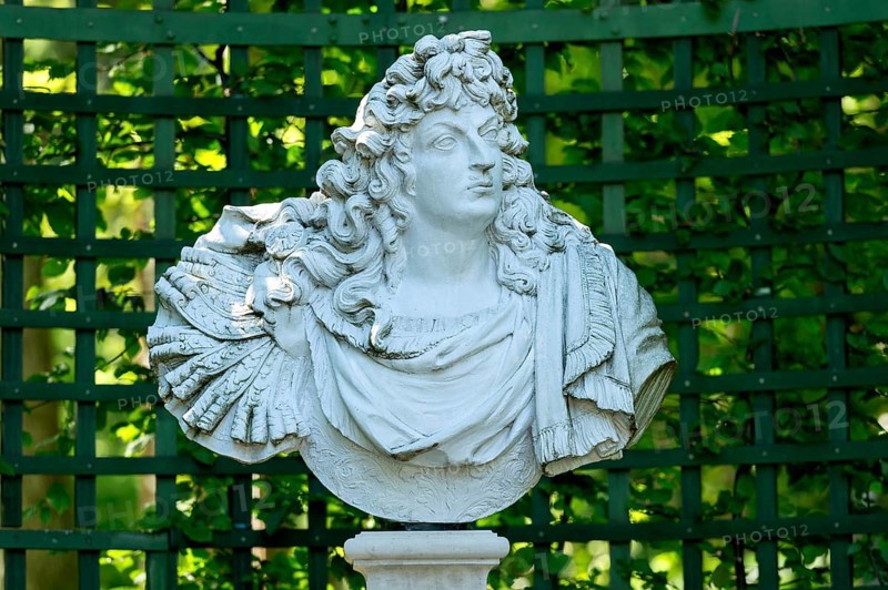 Decorative male bust in the garden archway