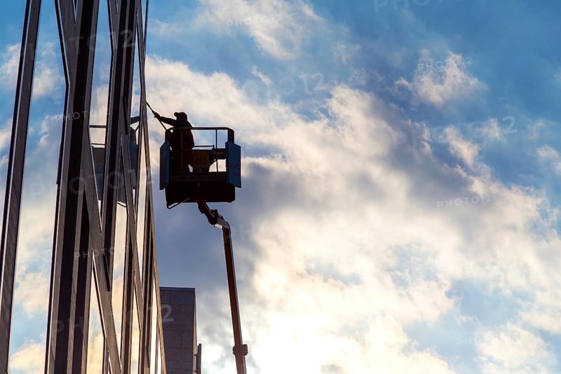 Window cleaner cleaning the windows of a hotel