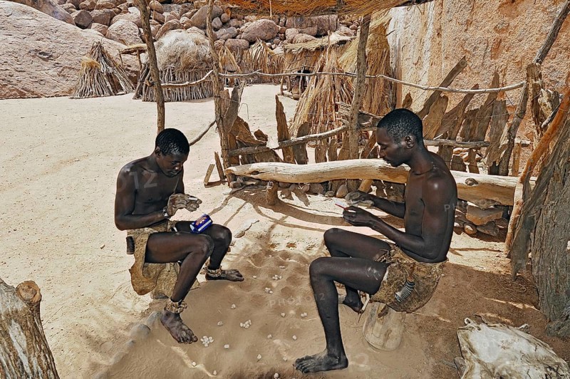 Two local men rolling cigarettes