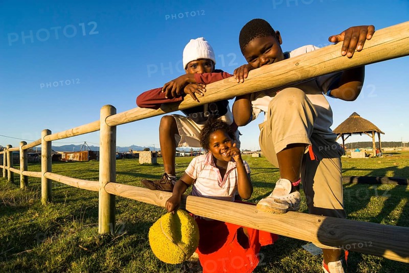 Two boys and a girl with a ball