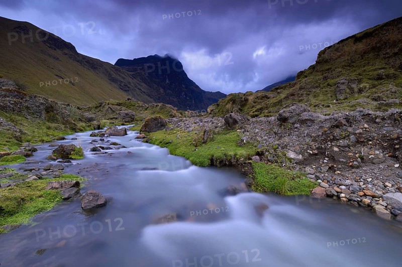Mountain stream with the peaks of El Altar or Kapak Urku