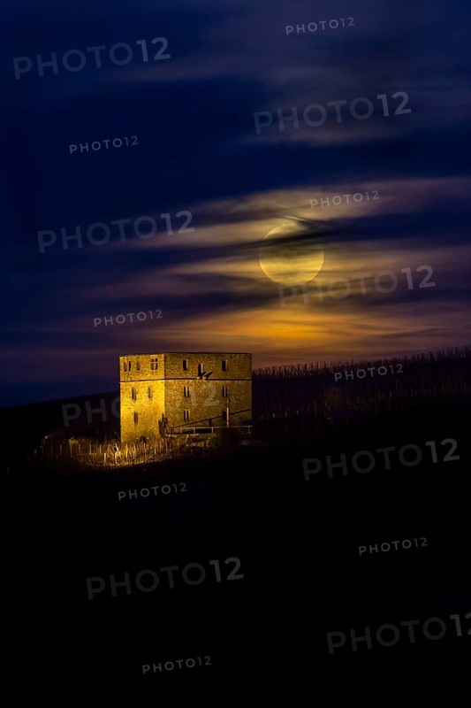 Ruins of Burg Y-burg Castle with a full moon