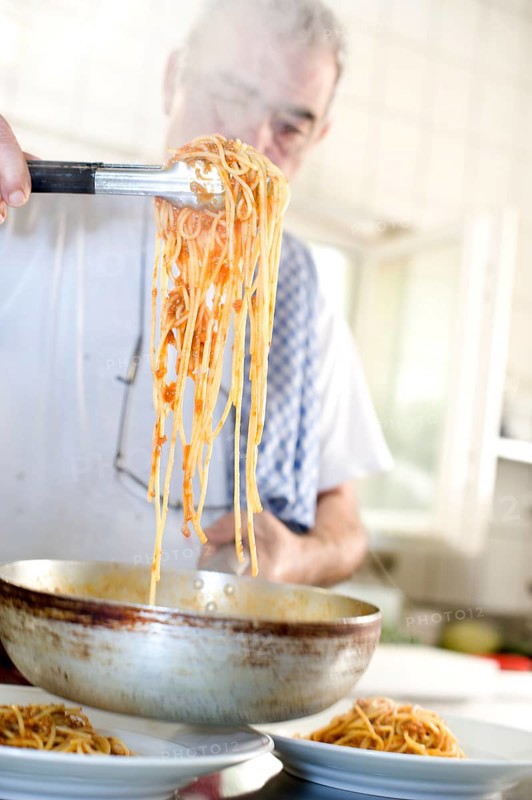 Chef dishing up spaghetti