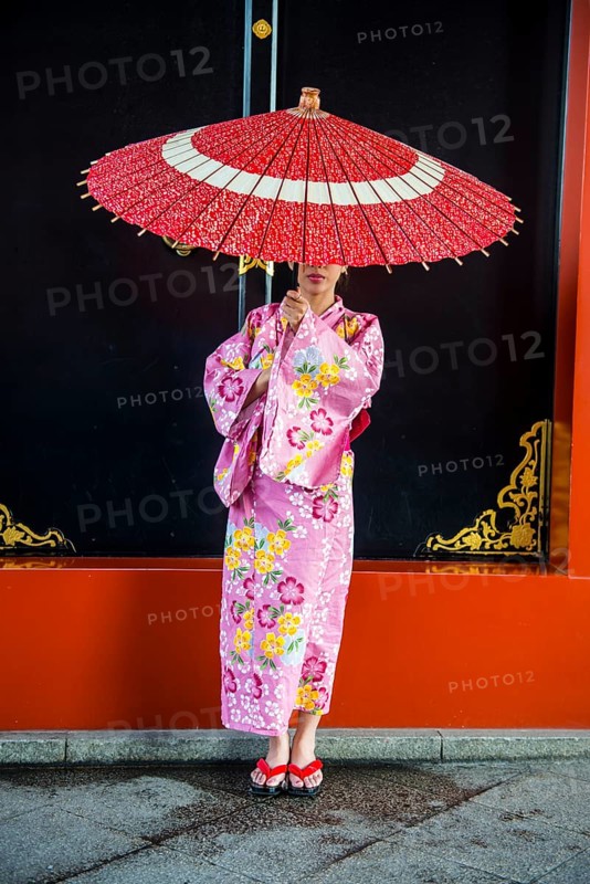 Young woman in kimono and with oil-paper umbrella