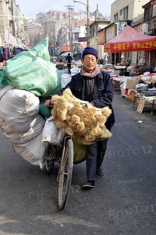 Man transporting goods with a bicycle