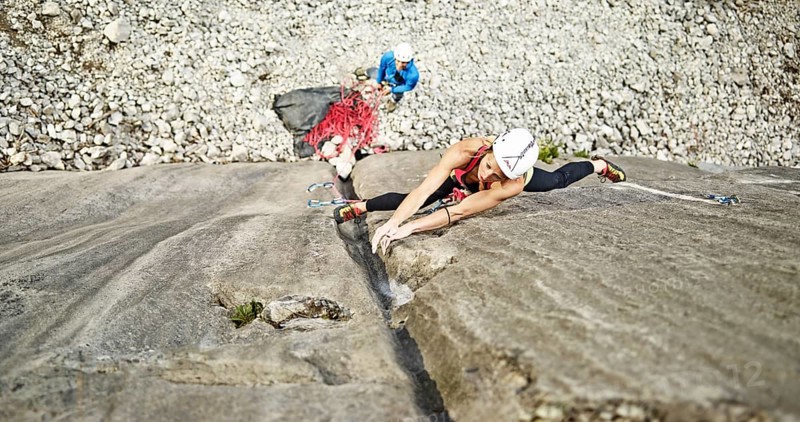 Woman lead climbing a gully
