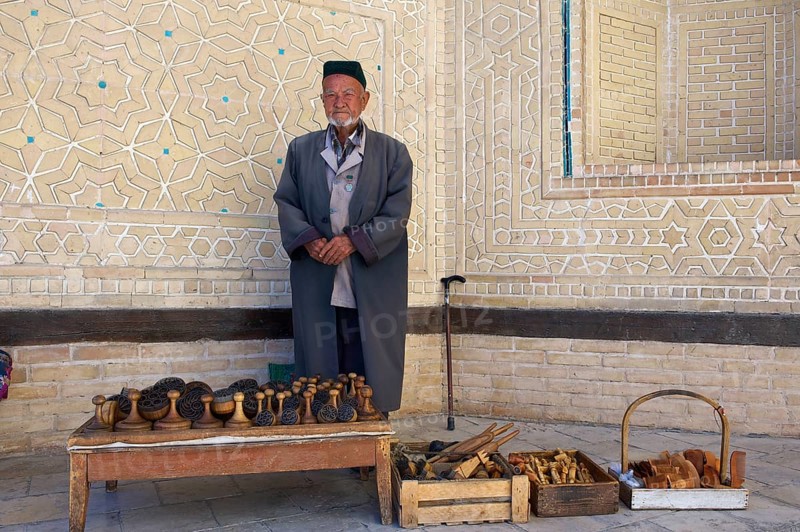 Local man with bread stamps in front of the Kalon Mosque