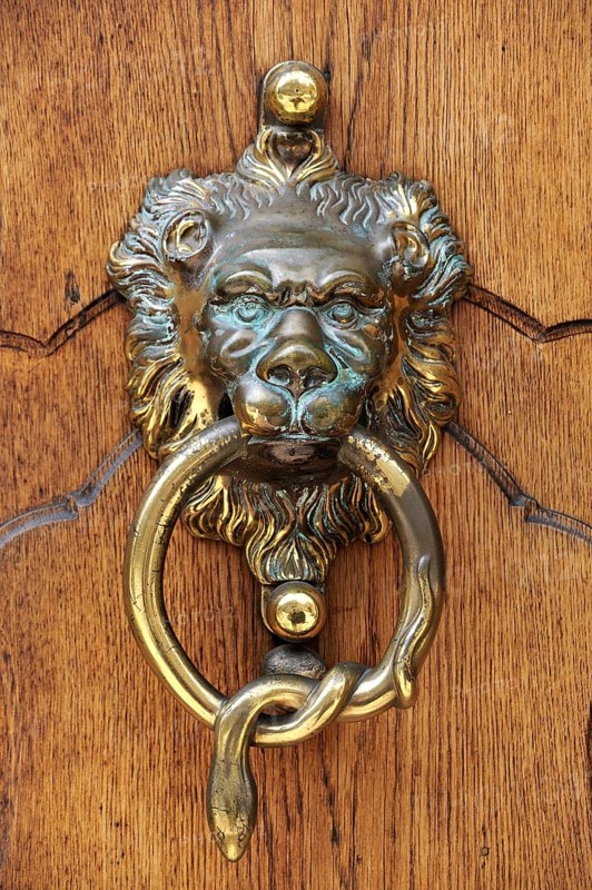 Lion head as a door knocker at the entrance portal