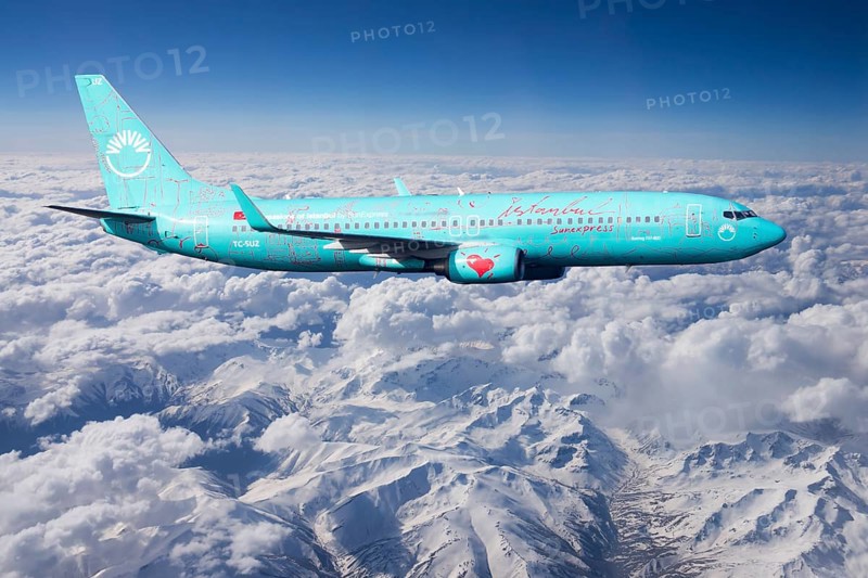 SunExpress Boeing 737 in flight over mountains