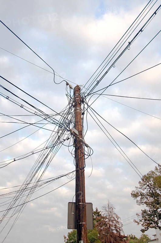 Telephone pole with tangled cables