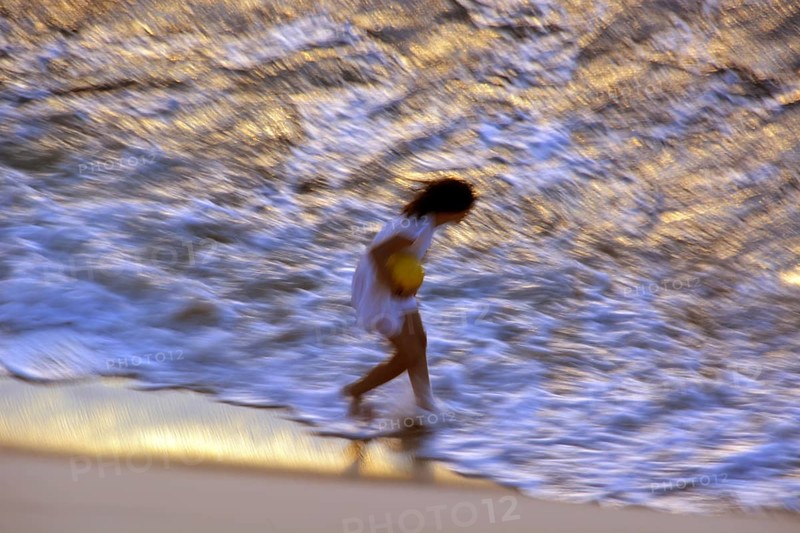 Woman on the beach in the evening