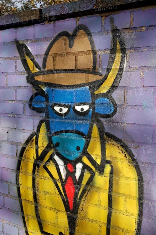 Ox figure wearing a tie and a hat