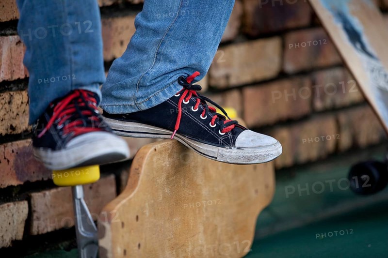 Teenager's feet on longboard