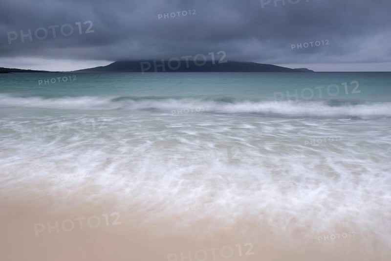 Mount Ceapabhal veiled by dark rain clouds on the horizon