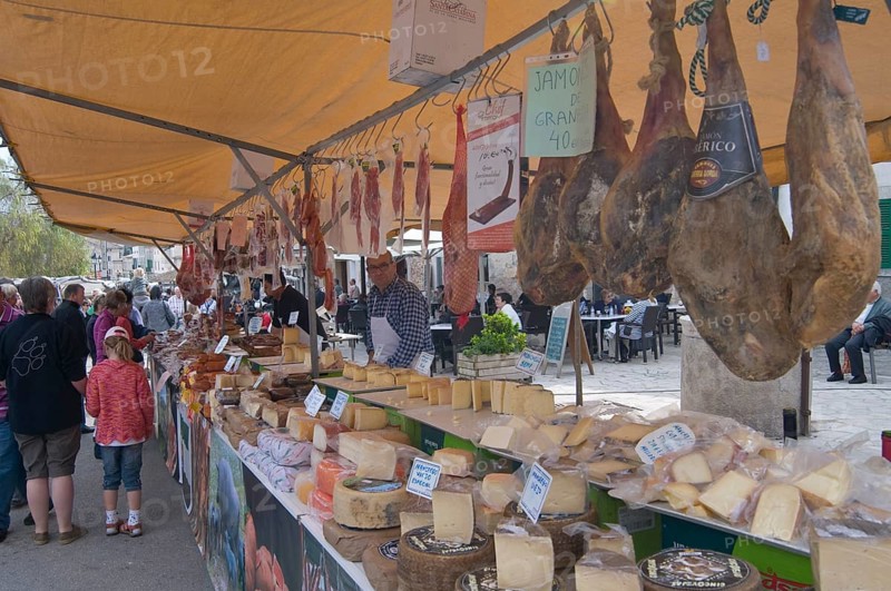 Market stall selling sausages and cheeses